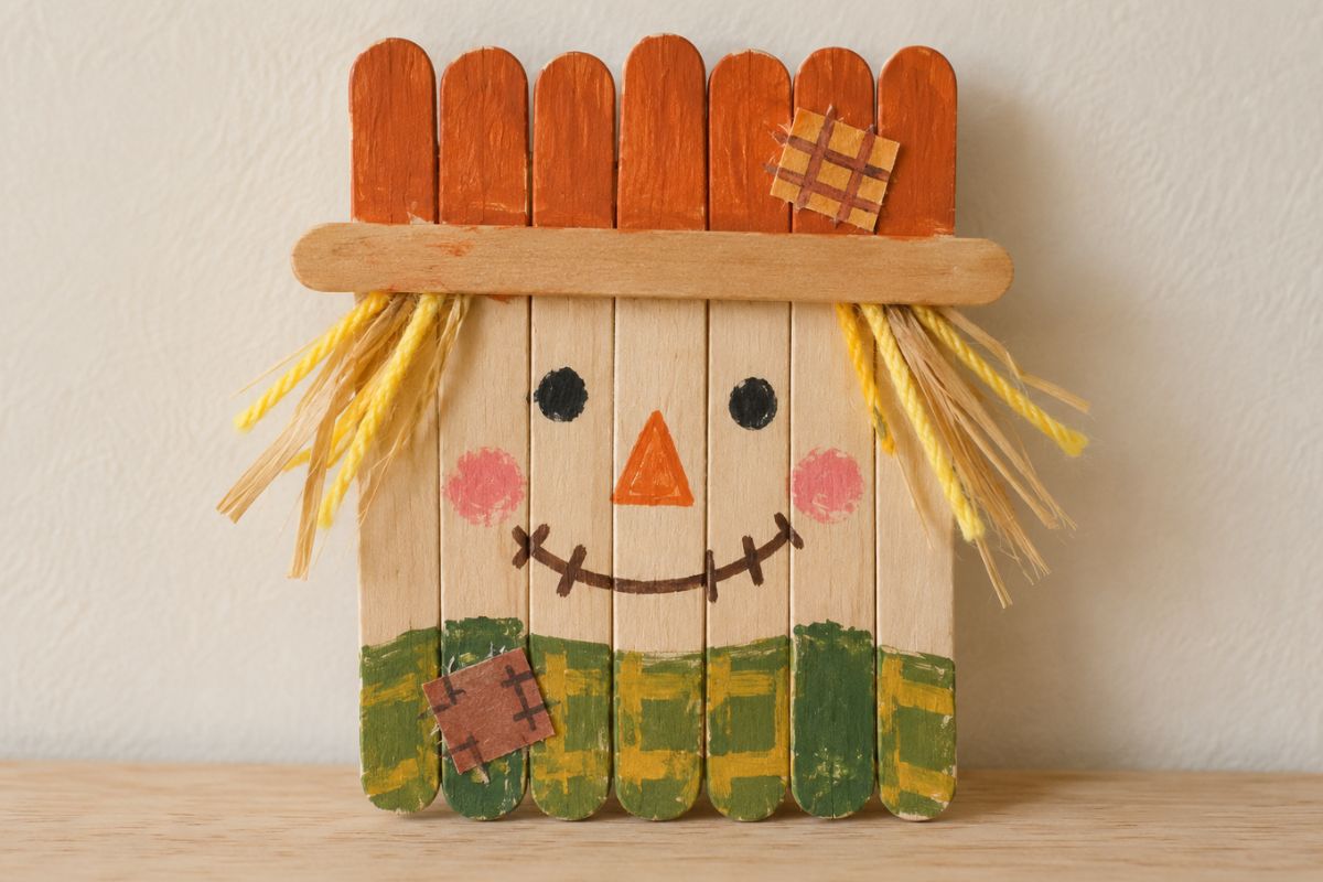 Herbst basteln mit Kindern: Vogelscheuche aus bemalten Eisstielen
